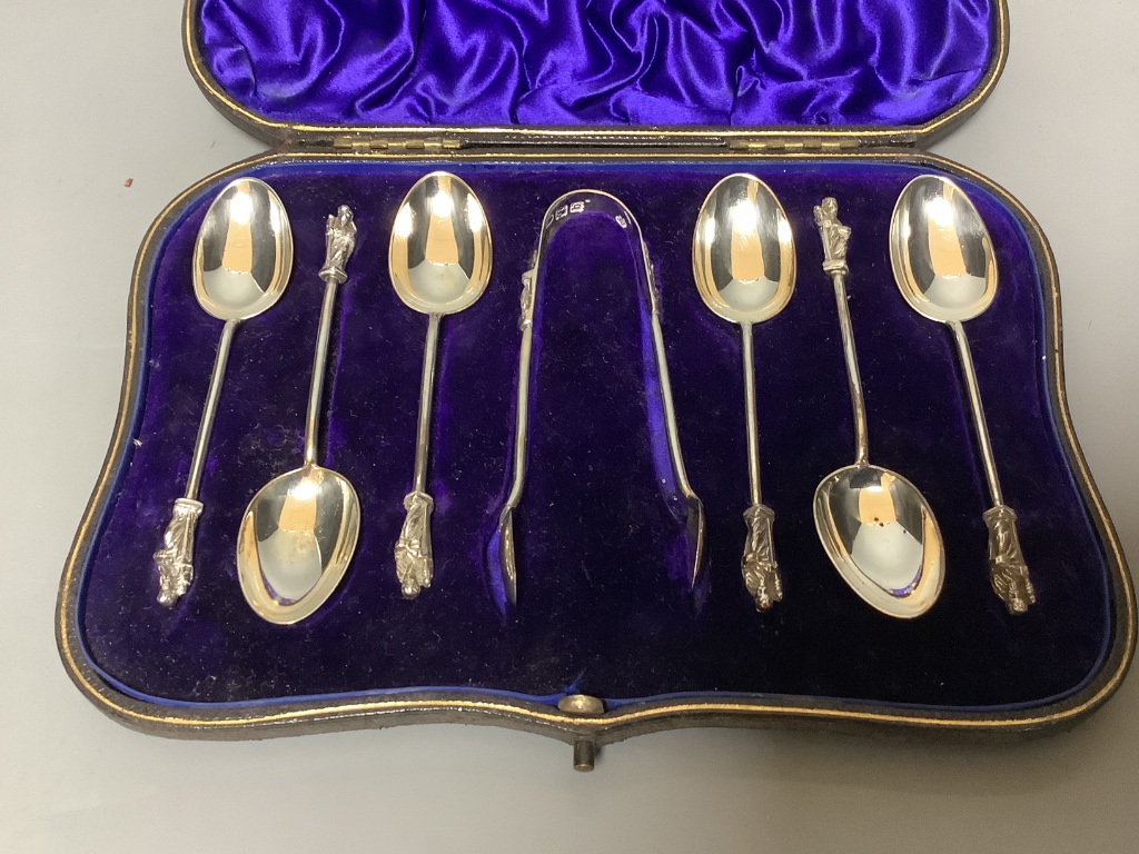 Twelve pairs of Walker & Hall silver-bladed bone-handled fish eaters, a set of six silver Apostle teaspoons and sugar tongs and a set of twelve silver coffee spoons